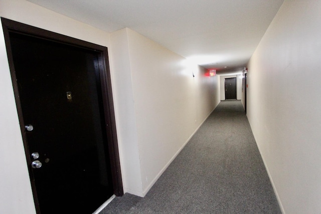 hall with carpet and baseboards