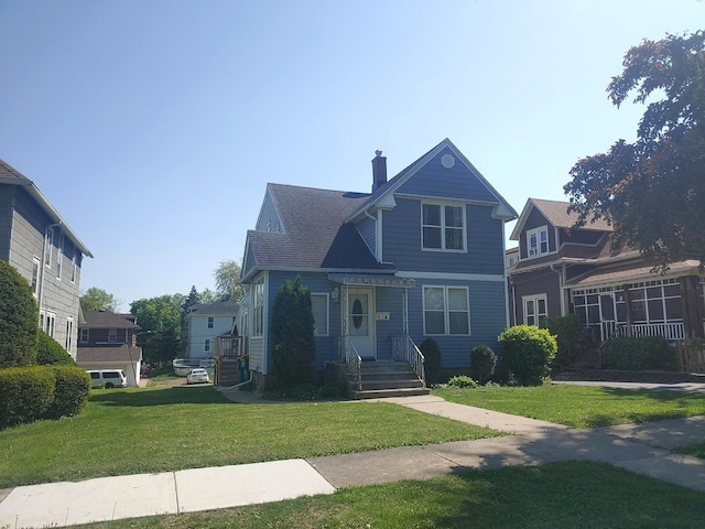 victorian-style house with a chimney and a front yard