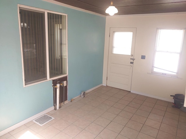 entrance foyer featuring baseboards and light tile patterned floors
