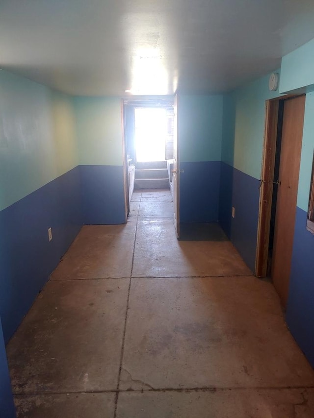 hall featuring concrete floors