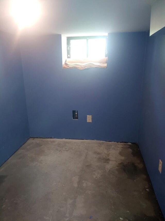unfurnished room featuring concrete floors