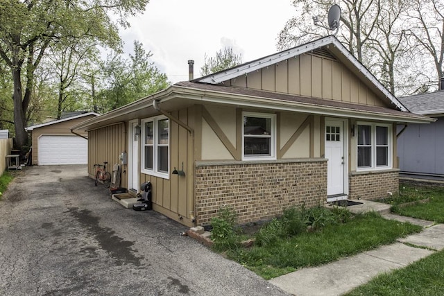 19451 W Hoag Ct, Mundelein, IL 60060 - view of front of property with brick siding, board and batten siding, a garage, and an outdoor structure
