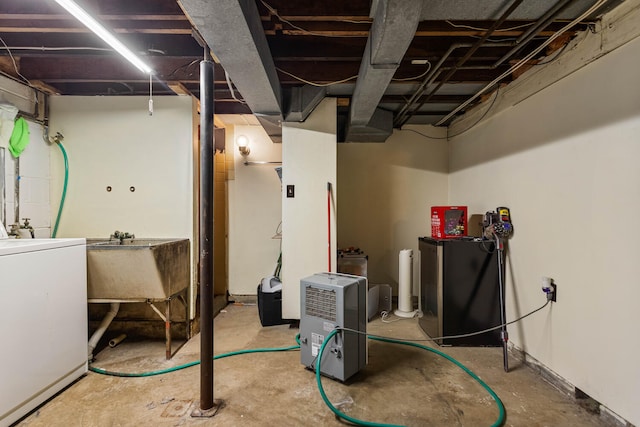 basement featuring washer / clothes dryer and a sink
