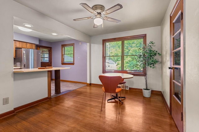 dining space featuring baseboards, light wood finished floors, and healthy amount of natural light