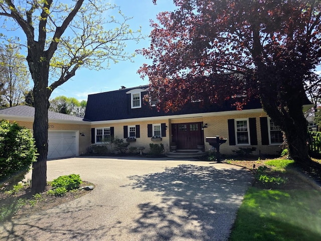 1215 Heather Ln, Glenview, IL 60025 - cape cod home featuring an attached garage, brick siding, and driveway