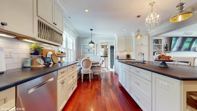 1215 Heather Ln, Glenview, IL 60025 - kitchen featuring stainless steel dishwasher, dark countertops, a sink, crown molding, and dark wood finished floors