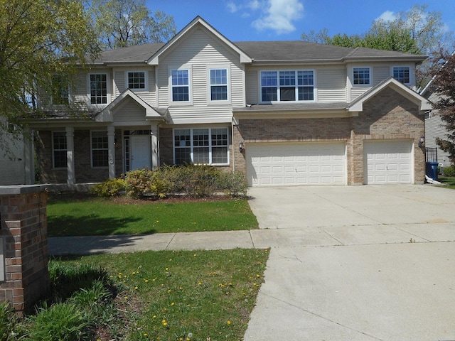 view of front of house with a garage, concrete driveway, brick siding, and a front yard