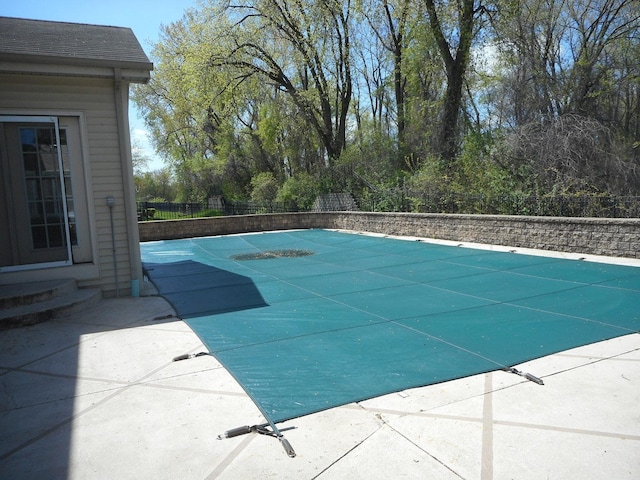 view of pool with fence, a patio area, and entry steps