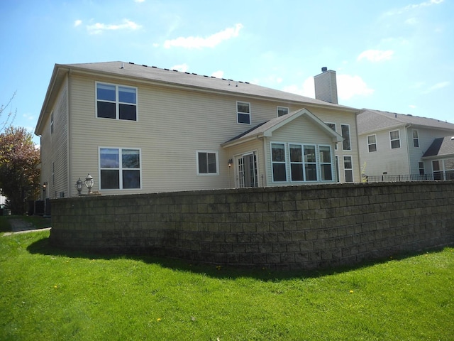 back of house with a chimney