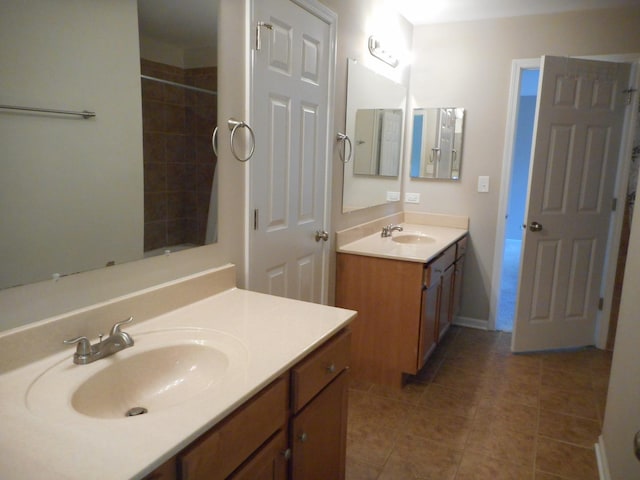bathroom featuring tile patterned floors, two vanities, and baseboards