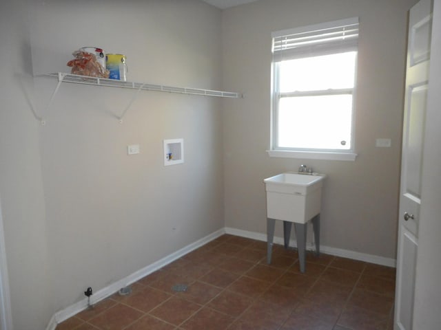 clothes washing area featuring washer hookup and baseboards