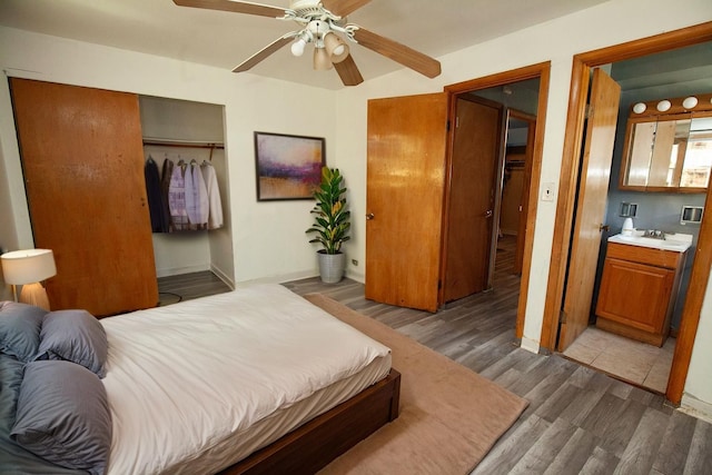 bedroom with wood finished floors, a closet, baseboards, and ceiling fan