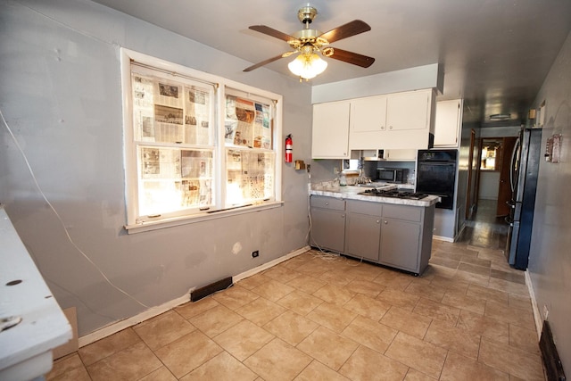 kitchen with black appliances, ceiling fan, a peninsula, white cabinetry, and light countertops