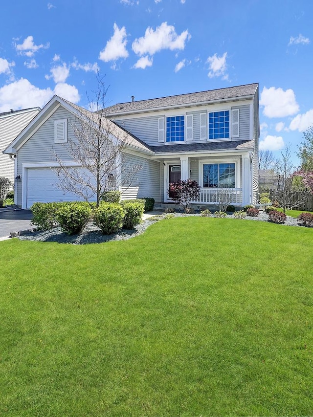 127 Bay View Ln, Grayslake, IL 60030 - traditional-style house with a porch, a front yard, and driveway