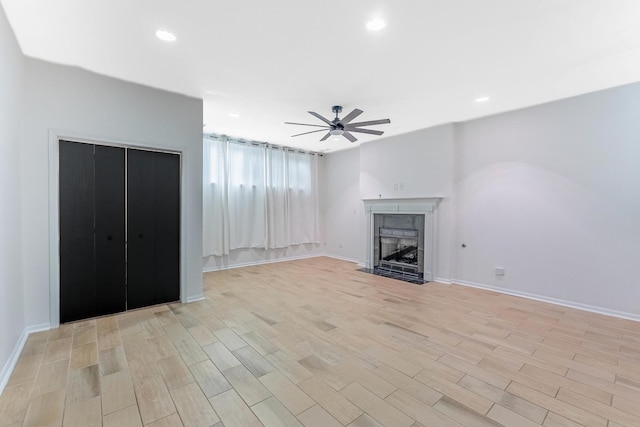 1107 S Independence Blvd Unit 1, Chicago, IL 60624 - unfurnished living room with a ceiling fan, light wood finished floors, a tiled fireplace, baseboards, and recessed lighting