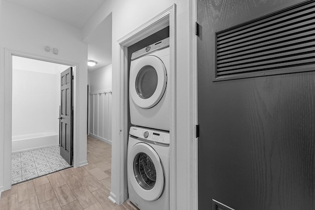 1107 S Independence Blvd Unit 1, Chicago, IL 60624 - laundry area featuring stacked washing machine and dryer and light wood-type flooring