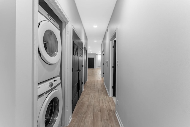 1107 S Independence Blvd Unit 1, Chicago, IL 60624 - washroom featuring estacked washer and dryer, recessed lighting, light wood finished floors, and baseboards