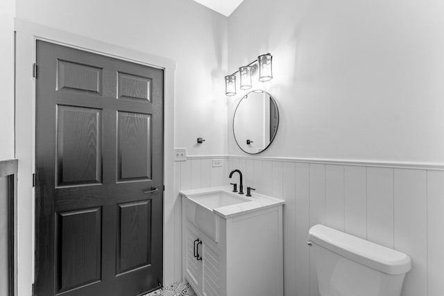 1107 S Independence Blvd Unit 1, Chicago, IL 60624 - half bath featuring a wainscoted wall, toilet, and vanity