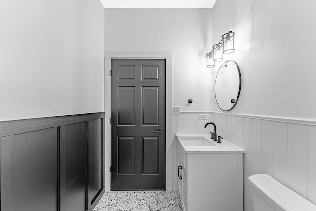 1107 S Independence Blvd Unit 1, Chicago, IL 60624 - bathroom with a wainscoted wall, toilet, vanity, and tile patterned flooring