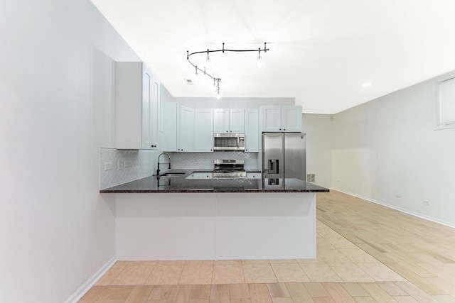 1107 S Independence Blvd Unit 1, Chicago, IL 60624 - kitchen with appliances with stainless steel finishes, a sink, a peninsula, dark stone countertops, and decorative backsplash