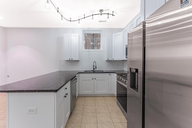 1107 S Independence Blvd Unit 1, Chicago, IL 60624 - kitchen with a sink, stainless steel appliances, a peninsula, backsplash, and white cabinets