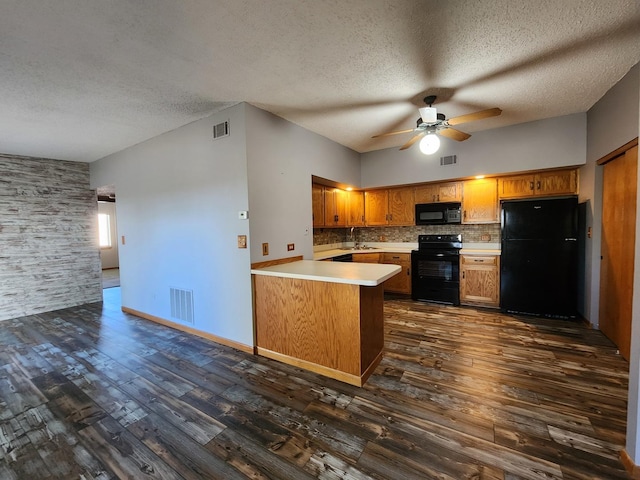 kitchen featuring black appliances, ceiling fan, a peninsula, a textured ceiling, and brown cabinetry