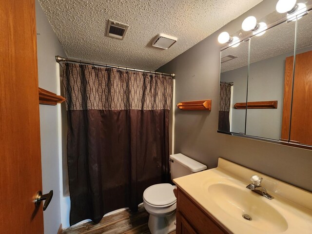 3115 Ingalls Ave Unit 3D, Joliet, IL 60435 - full bath featuring wood finished floors, vanity, toilet, a textured ceiling, and shower / tub combo