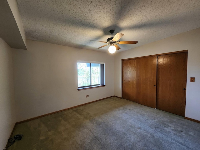 unfurnished bedroom with carpet floors, baseboards, a closet, ceiling fan, and a textured ceiling