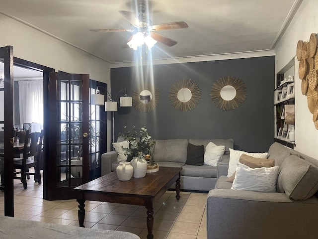 living room with ornamental molding, light tile patterned flooring, and a ceiling fan