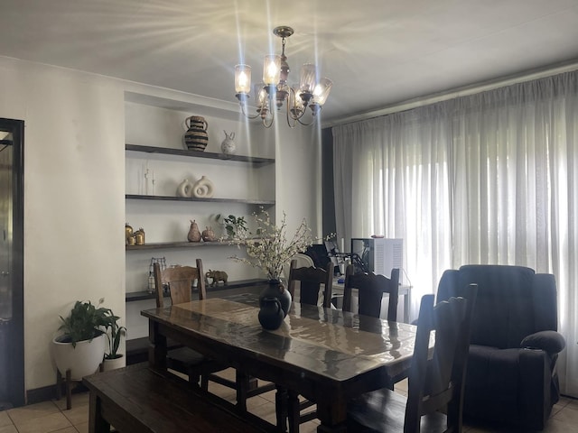 dining space with a chandelier and light tile patterned floors