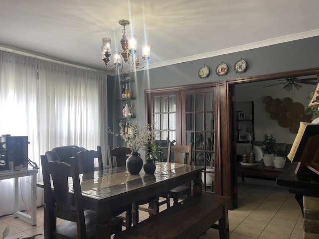 dining area featuring light tile patterned floors, a chandelier, plenty of natural light, crown molding, and a ceiling fan