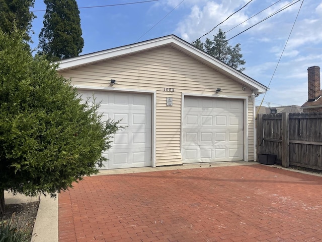 detached garage featuring fence