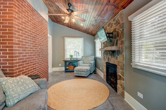 115 S Calumet Ave, Aurora, IL 60506 - living room featuring a stone fireplace, wood ceiling, ceiling fan, baseboards, and lofted ceiling