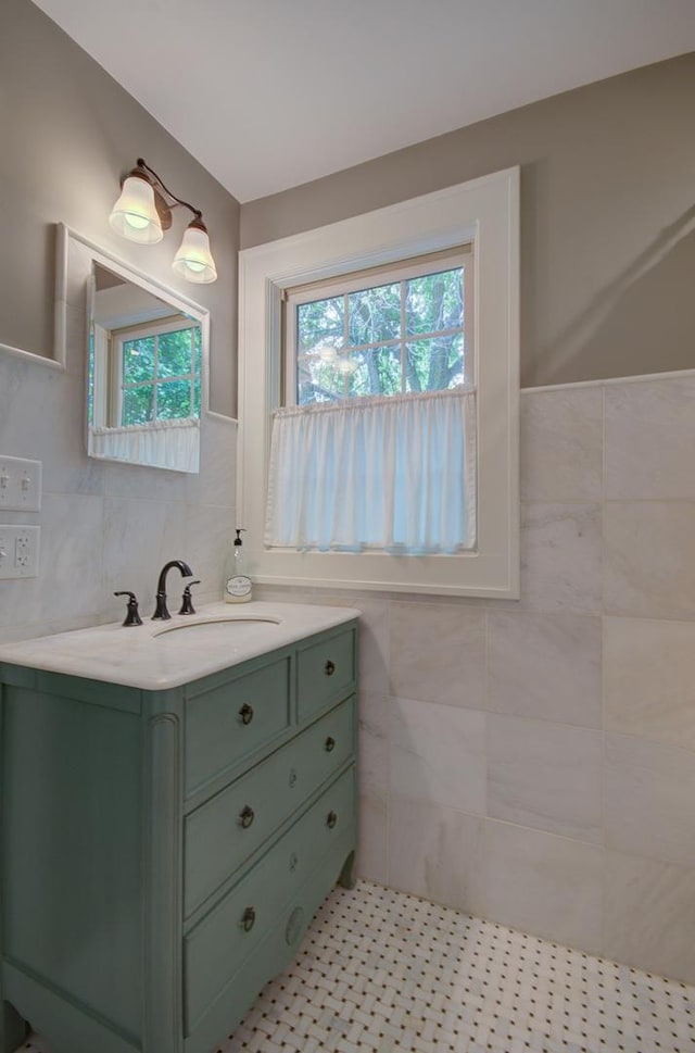 115 S Calumet Ave, Aurora, IL 60506 - bathroom with tile walls, vanity, wainscoting, and tile patterned floors