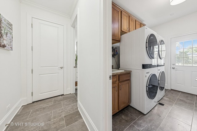 8250 Steepleside Dr, Burr Ridge, IL 60527 - laundry area with cabinet space, stacked washing machine and dryer, baseboards, and crown molding