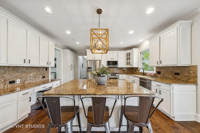 8250 Steepleside Dr, Burr Ridge, IL 60527 - kitchen with stainless steel appliances, a sink, white cabinets, a kitchen island, and tasteful backsplash