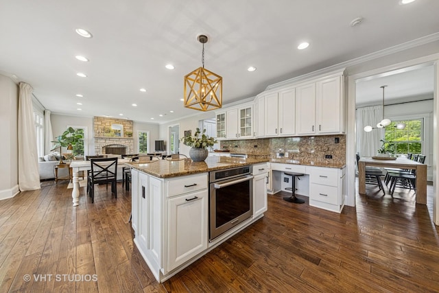 8250 Steepleside Dr, Burr Ridge, IL 60527 - kitchen with a chandelier, stainless steel oven, dark wood finished floors, stone counters, and white cabinetry