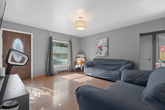 living area featuring wood finished floors and baseboards