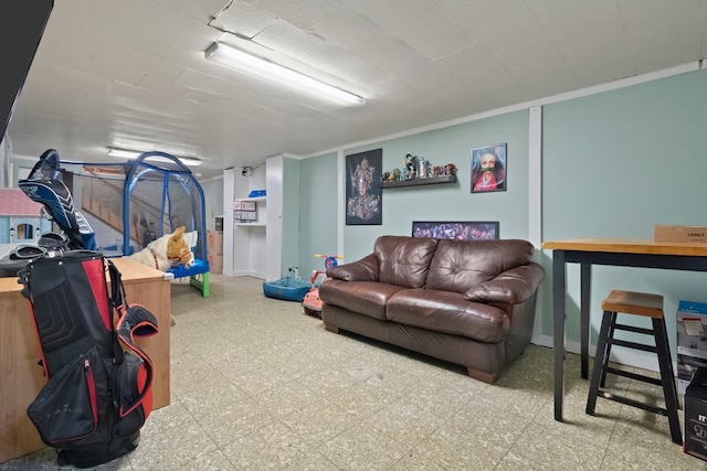 living area featuring tile patterned floors and crown molding