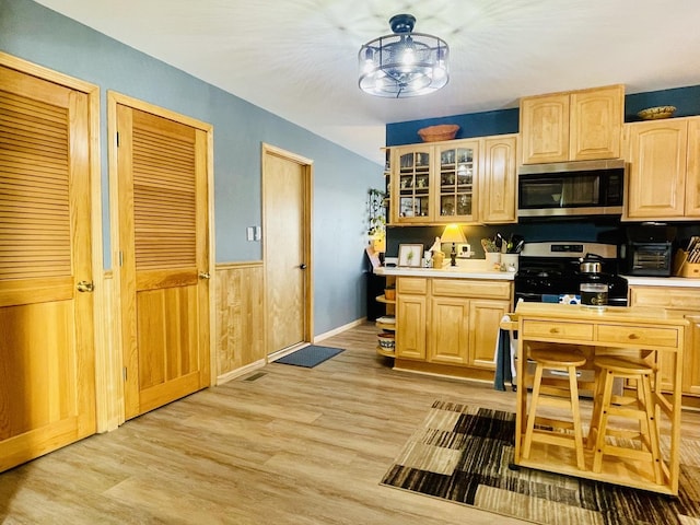18269 W Woodland Ter, Gurnee, IL 60031 - kitchen with appliances with stainless steel finishes, light brown cabinetry, light countertops, light wood-style flooring, and wainscoting