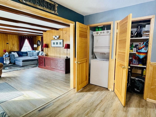 18269 W Woodland Ter, Gurnee, IL 60031 - clothes washing area with stacked washer / drying machine, light wood-style flooring, and wood walls