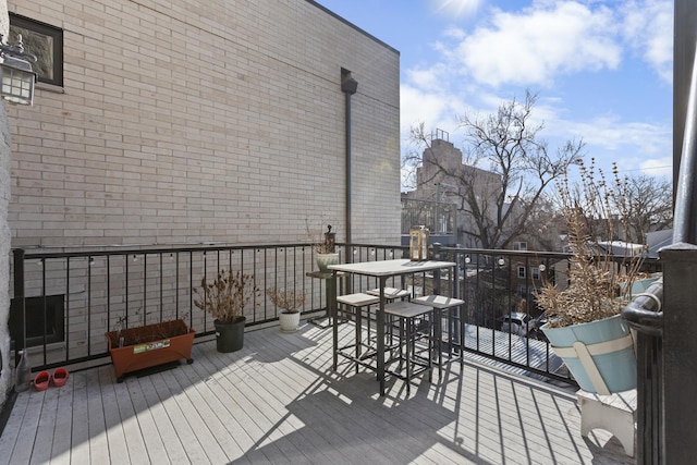 wooden terrace featuring outdoor dining space