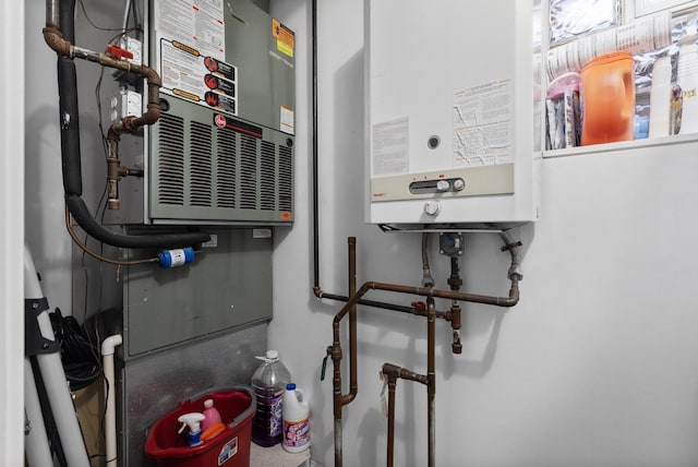 utility room featuring water heater and heating unit