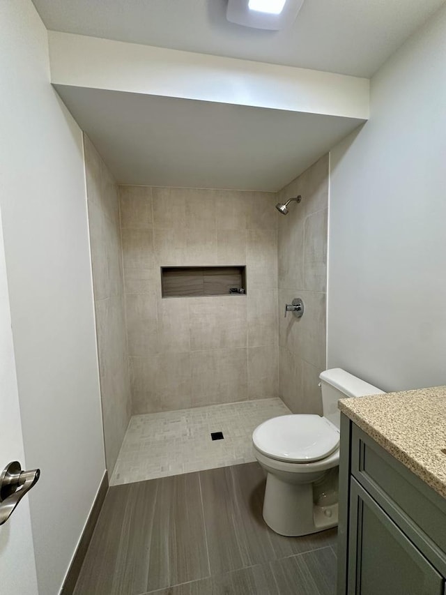 302 S 7th Ave, Maywood, IL 60153 - full bath featuring toilet, tiled shower, vanity, and wood finished floors