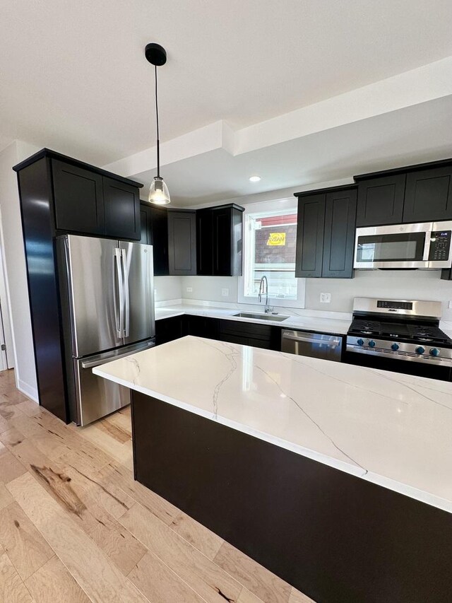 302 S 7th Ave, Maywood, IL 60153 - kitchen with appliances with stainless steel finishes, a sink, dark cabinetry, light stone counters, and hanging light fixtures
