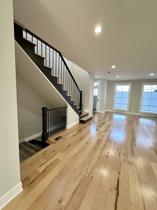 302 S 7th Ave, Maywood, IL 60153 - unfurnished living room with hardwood / wood-style flooring, baseboards, recessed lighting, and stairs