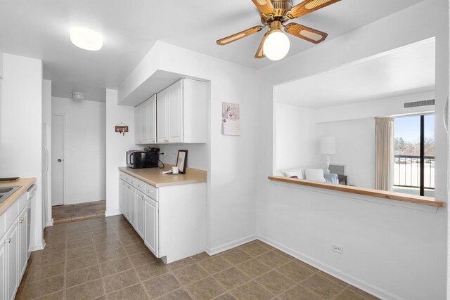 1415 E Central Rd Unit 421C, Arlington Heights, IL 60005 - kitchen featuring ceiling fan, light countertops, white cabinetry, and baseboards