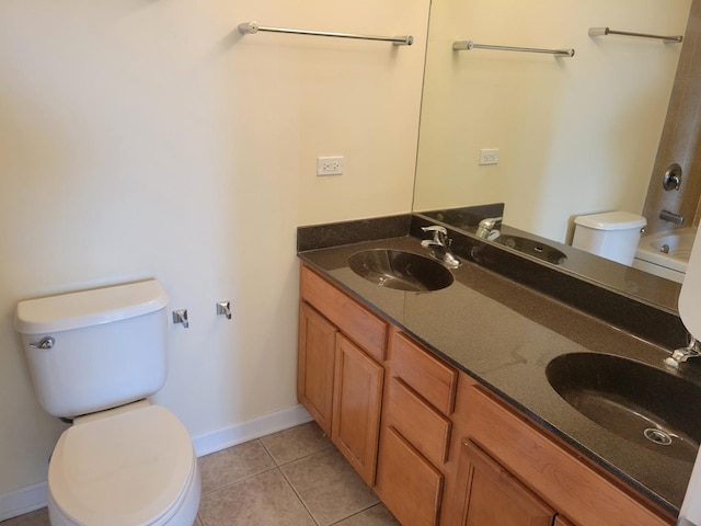 50 S Grove Ave Unit 510, Elgin, IL 60120 - bathroom featuring toilet, tile patterned floors, double vanity, baseboards, and bathing tub / shower combination