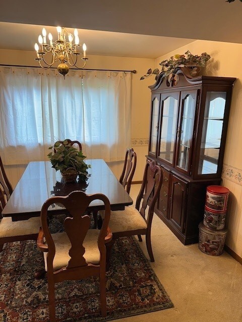 3806 Juniper Ave, Joliet, IL 60431 - dining space featuring carpet, a chandelier, and baseboards