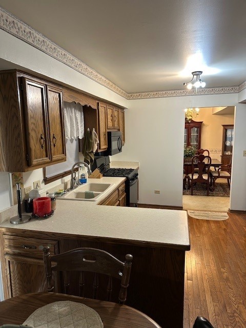 3806 Juniper Ave, Joliet, IL 60431 - kitchen featuring a sink, black appliances, and light countertops